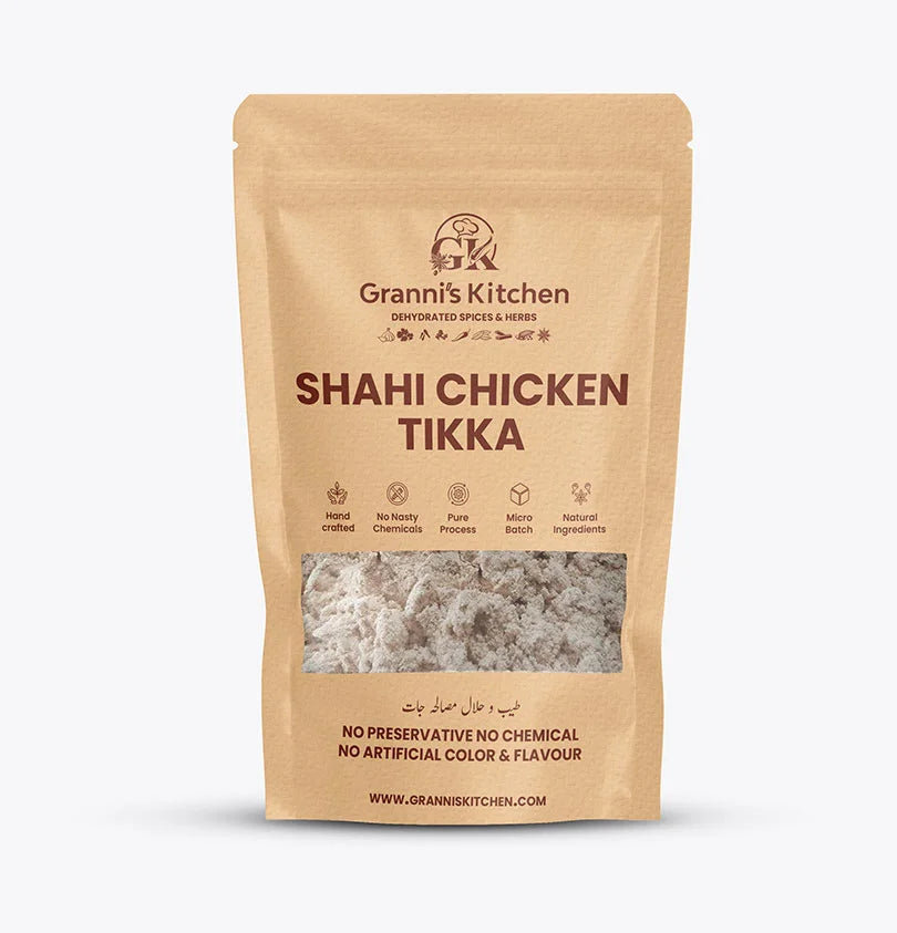 A package of Shahi Chicken Tikka by Grannis Kitchen with a spoonful of spiced chicken pieces in front, against a white background.